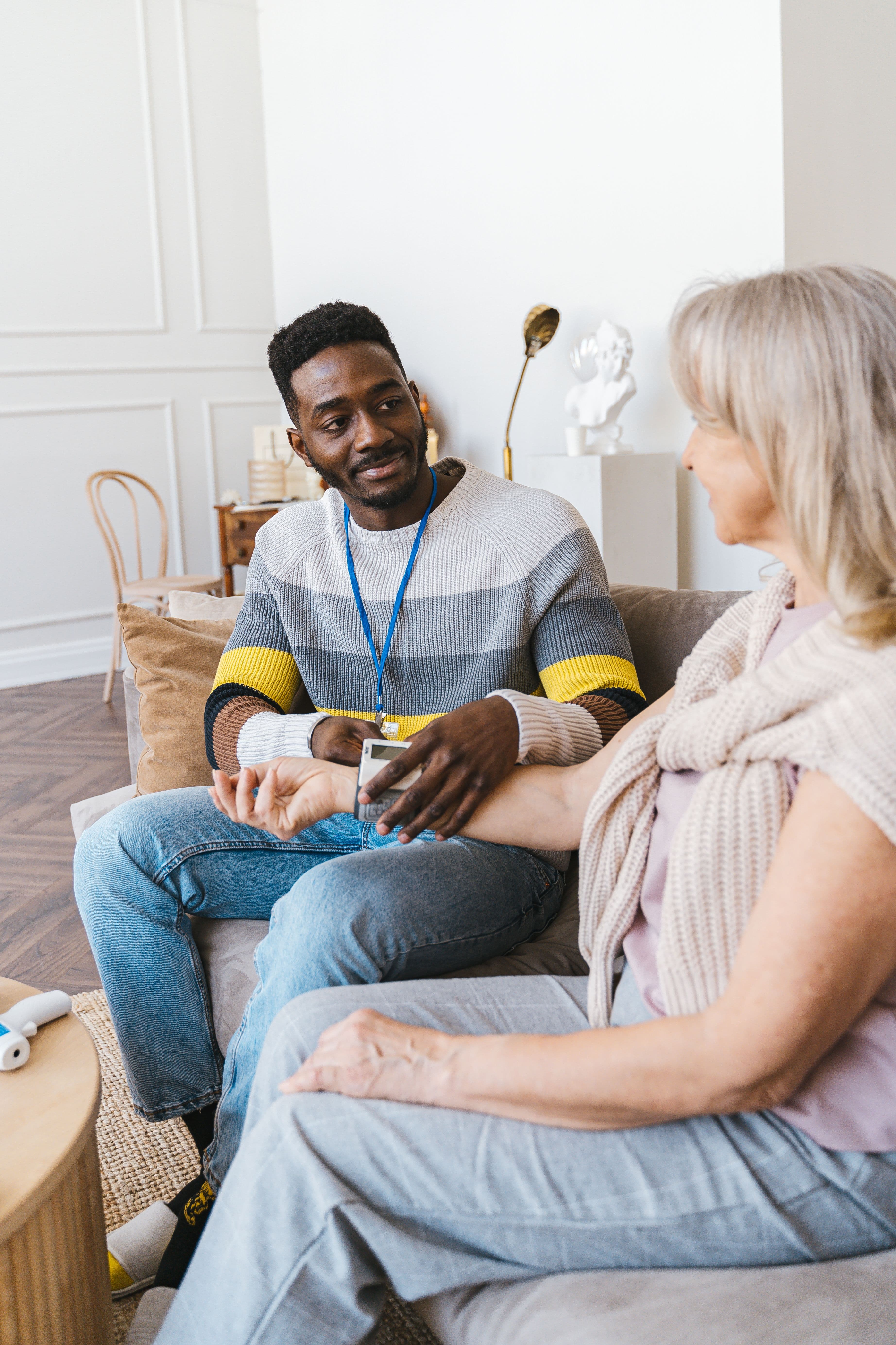 Care professional checking on a senior client at home